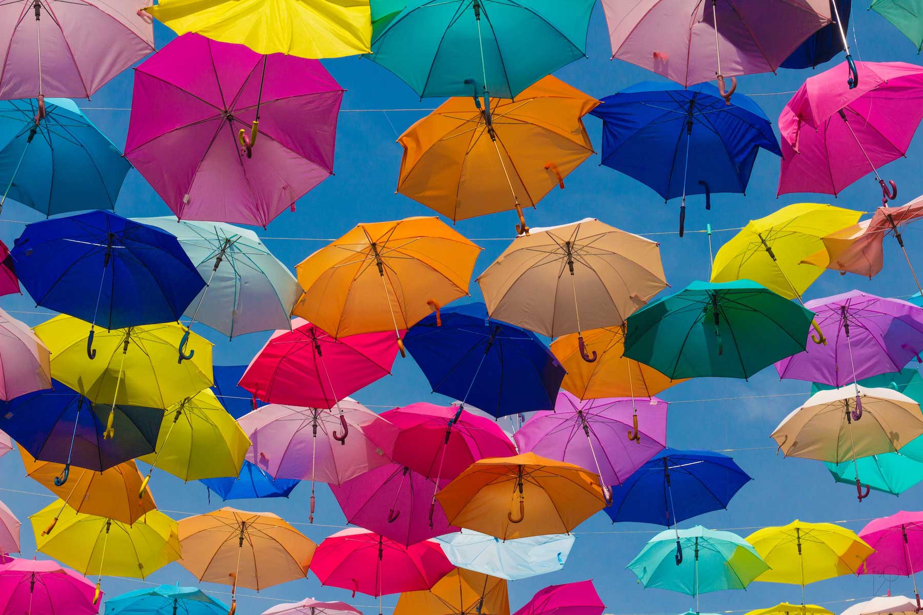 ulises-baga-oRYOOjvPq8E-unsplash-1 Ein Meer von farbigen Regenschirmen am Himmel